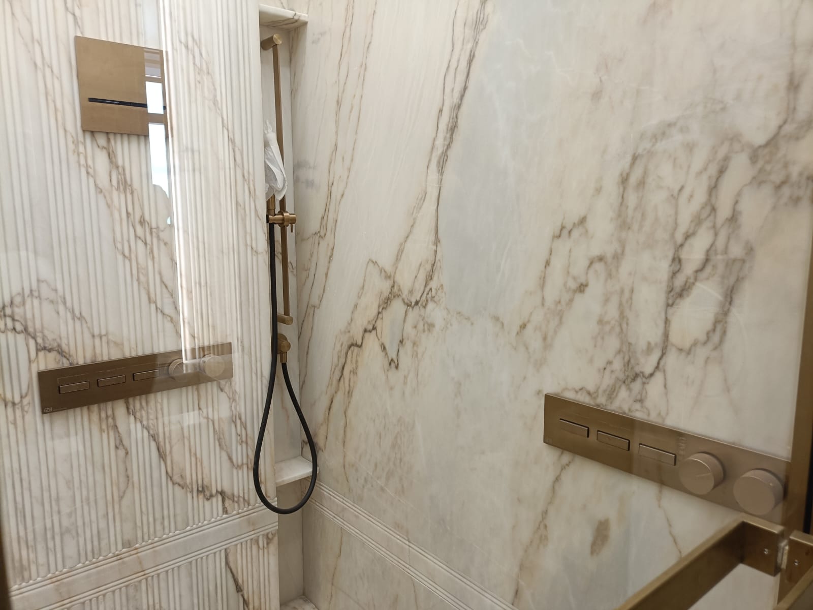 Marble shower enclosure with concealed brass mixer