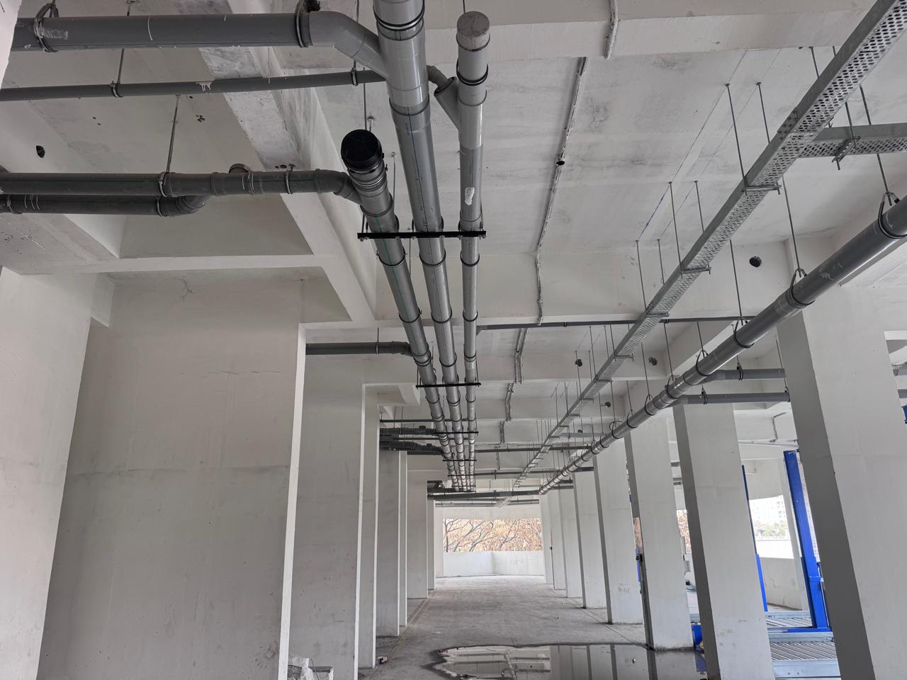 Overhead drainage network at podium level slab