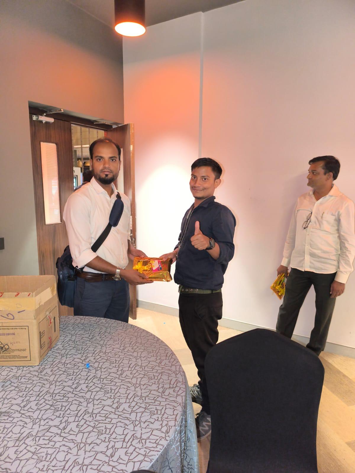 Team member being felicitated with a gift at office event